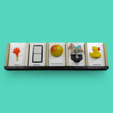 The Calendar tactile accesory each slot holds a tangible or symbol card holder with a built-in back compartment offers convenient storage for extra cards or can be used as a “finished” section, allowing users to move completed activities out of view and reinforce a sense of progress and routine. Thoughtfully designed for use at home, in classrooms, or in therapy settings, this display helps make time, tasks, and transitions more concrete and accessible. 