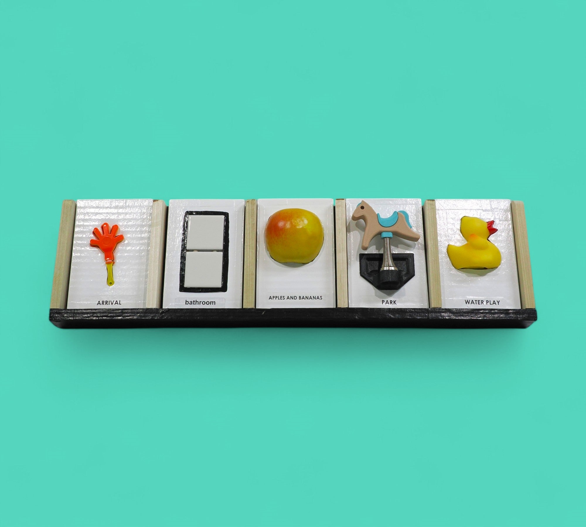 The Calendar tactile accesory each slot holds a tangible or symbol card holder with a built-in back compartment offers convenient storage for extra cards or can be used as a “finished” section, allowing users to move completed activities out of view and reinforce a sense of progress and routine. Thoughtfully designed for use at home, in classrooms, or in therapy settings, this display helps make time, tasks, and transitions more concrete and accessible. 