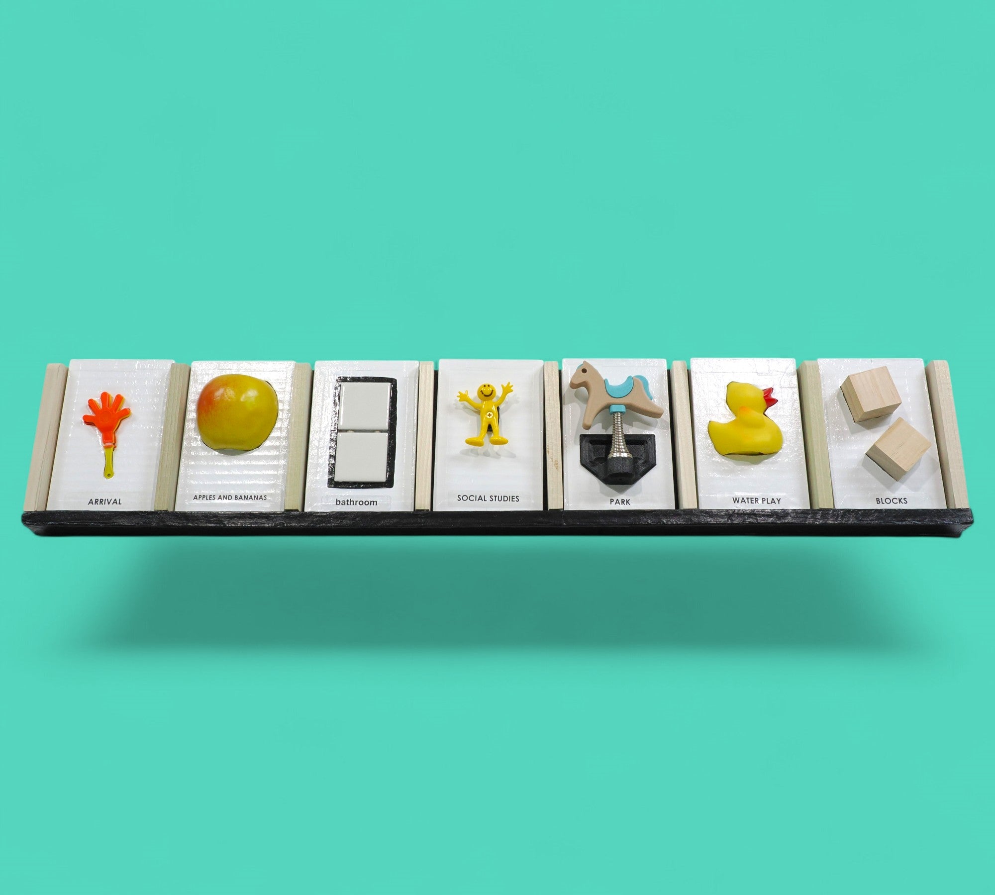 The Calendar tactile accesory each slot holds a tangible or symbol card holder with a built-in back compartment offers convenient storage for extra cards or can be used as a “finished” section, allowing users to move completed activities out of view and reinforce a sense of progress and routine. Thoughtfully designed for use at home, in classrooms, or in therapy settings, this display helps make time, tasks, and transitions more concrete and accessible. 