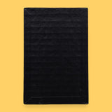 The Blank symbol card has no symbol embedded. Labeled "Blank" in white font at the bottom of symbol on clear backing. The background of the symbol is black.