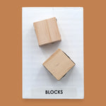 The Blocks symbol with two small wooden blocks embedded vertically. Labeled "Blocks" in black font on white backing at the bottom of symbol. The background of the symbol is white.
