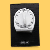 The Break Kitchen Timer symbol has a 3D shaped white kitchen timer with black numbering with a movable dial that is embedded in the center of the card with white backing. Labeled "Break" in white font at the bottom of symbol on clear backing. The background of the symbol is black.