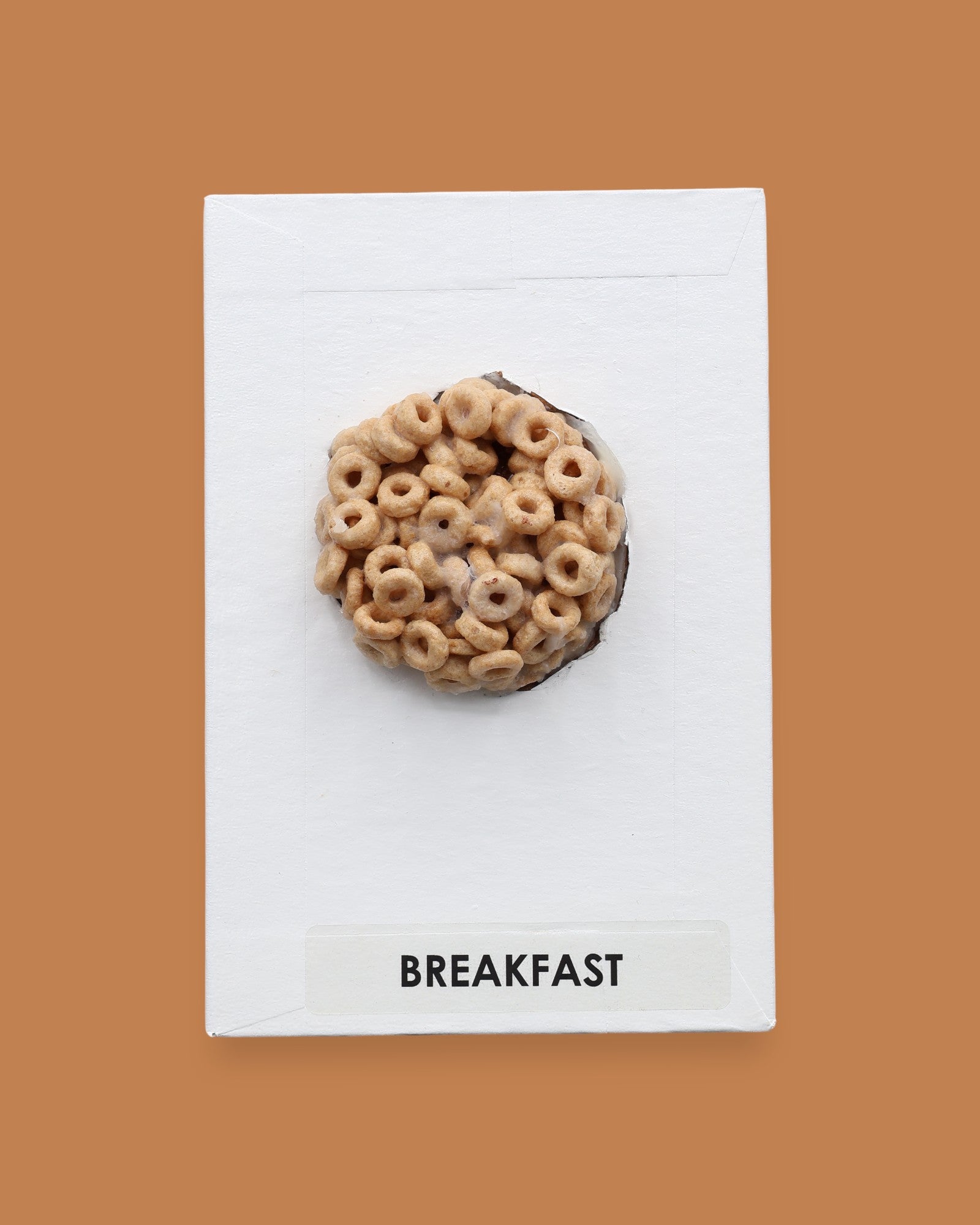The Breakfast Cereal Box symbol has a small cereal box is embedded in the center of the card, with the option to customize the card using a with white backing for increased contrast. The color of the box may vary. Labeled "Cereal" in black font at the bottom of symbol on white backing. 