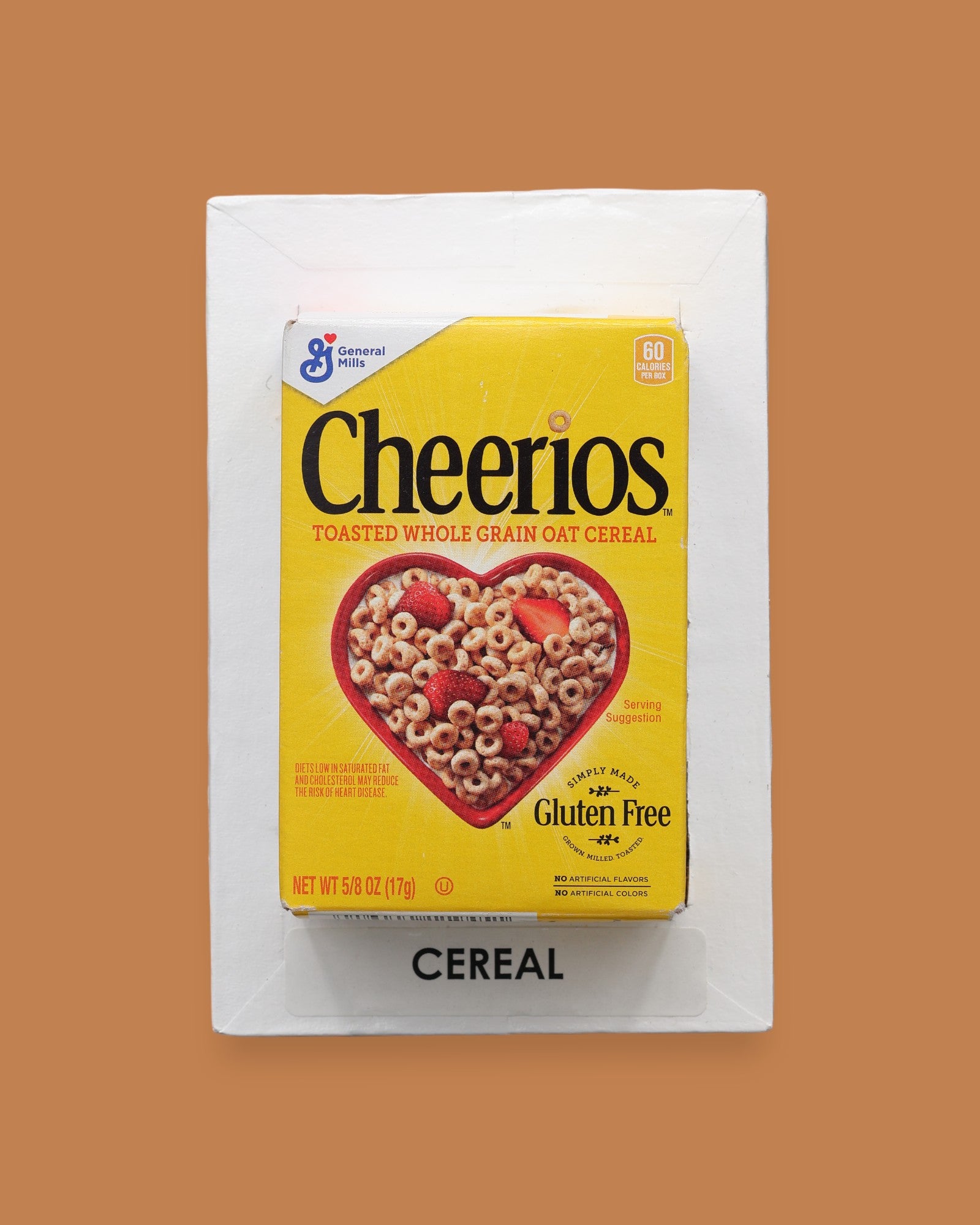 The Breakfast Loose Cereal symbol a carefully prepared blend of hot glue and toasted O’s cereal, formed into a circular shape, is embedded at the center of the card, creating a visually engaging and tactile focal point. The card can be customized, using a black backing for increased contrast.