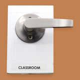 The Classroom symbol with a pushable metal door lever embedded horizontally. Labeled "Classroom" in black font on white backing at the bottom of the symbol. The background of the symbol is white. 