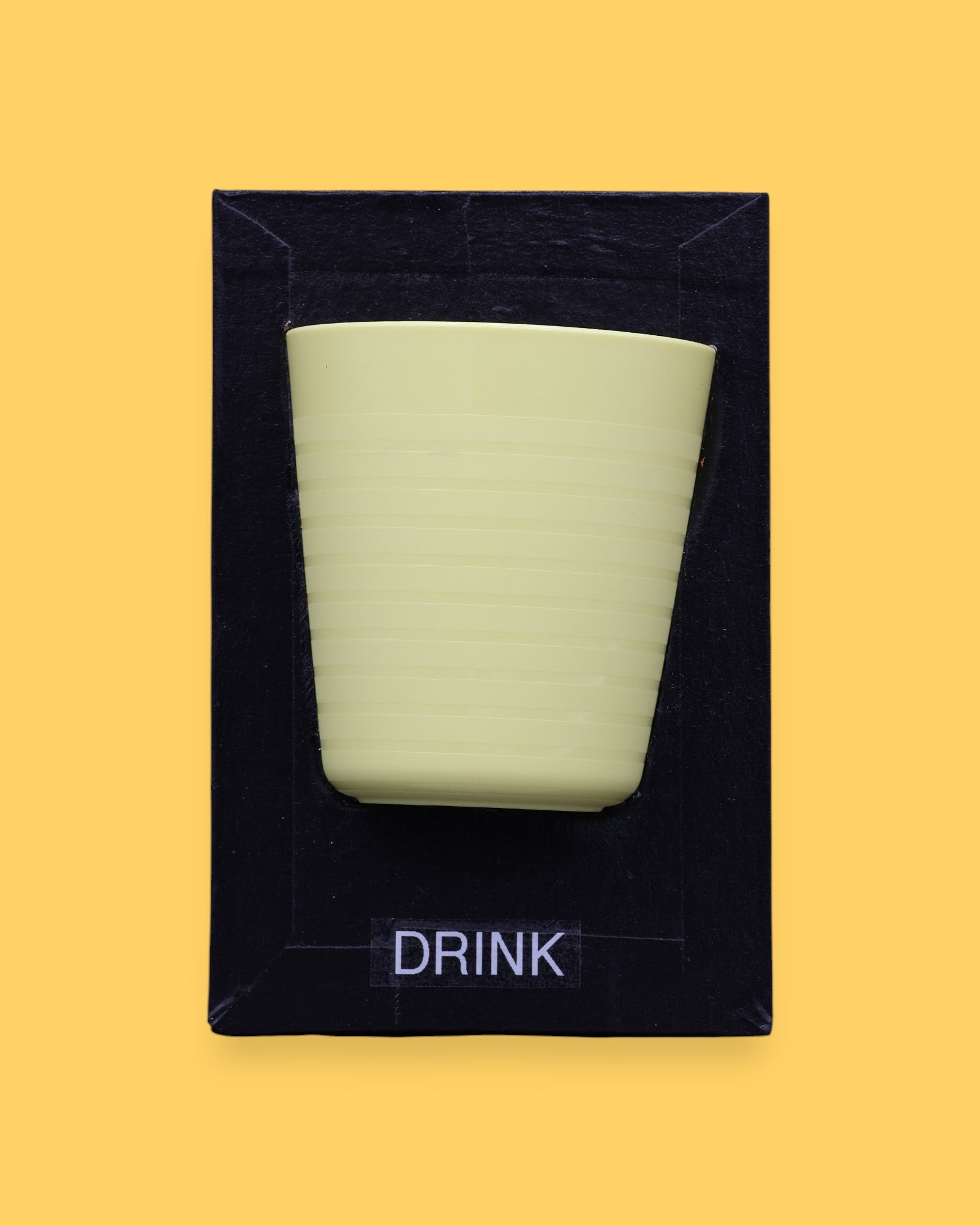The Drink symbol has a light green cup with horizontal ridges embedded. Labeled "Drink" in black font and white backing at the bottom of symbol. The background of the symbol is black.