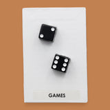 The Games symbol is with two black and white dice embedded diagonally. Labeled "Games" at the bottom of the symbol in black font on a white background. 