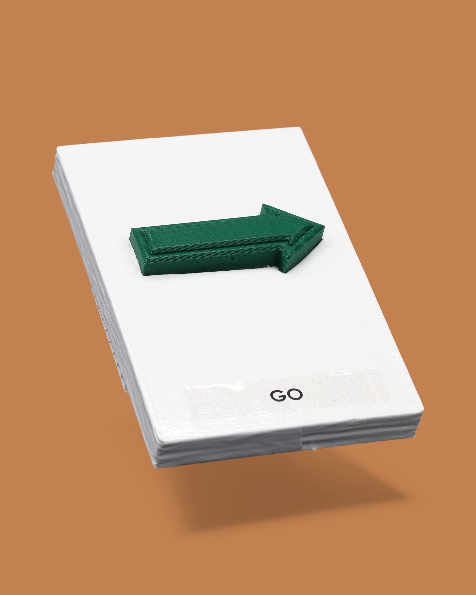 This image displays a standard white tactile card that is 4 by 6 inches in size.  The tactile card holds a layered green 3D arrow pointing to the right. The tactile card is labeled Go below the arrow.