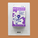 The Milk symbol has a pint size milk carton is embedded at the center of the symbol, creating a visually engaging and tactile focal point. Labeled "Milk" in black font at the bottom of symbol on white backing. The background of the symbol is white. This symbol can be customized, using a black backing for increased contrast.