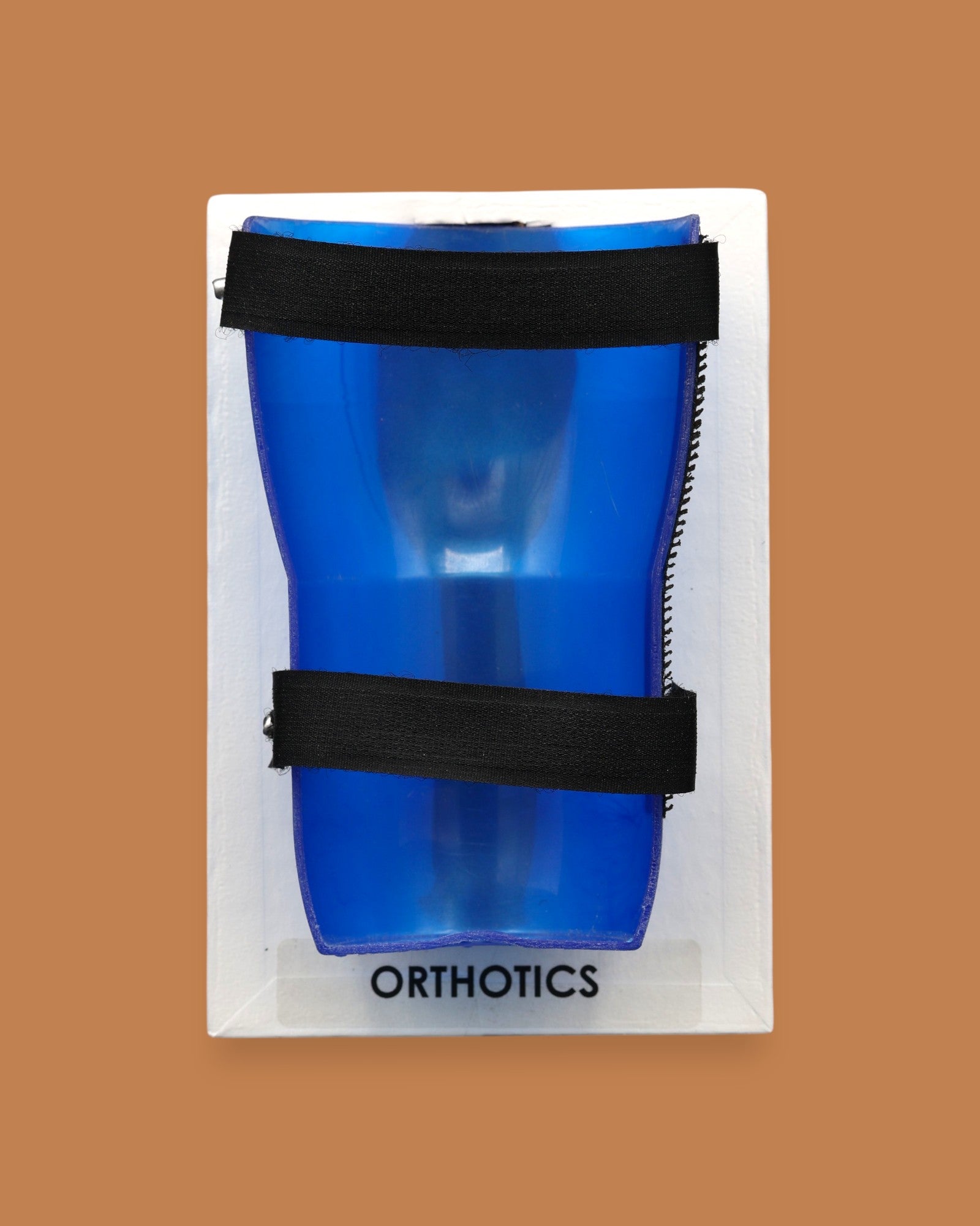 The Orthotics symbol with an embedded small child-like orthotic brace embedded in the center. Labeled "Orthotics" in black font on white backing at the bottom of the symbol. The background of the symbol is white. 