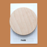 The Park Spinner symbol with a 3D printer wood-grain-like filament placed atop of a spinning embedded axel. Labeled "Park" in black font on white backing at the bottom of the symbol. The background of the symbol is white. 