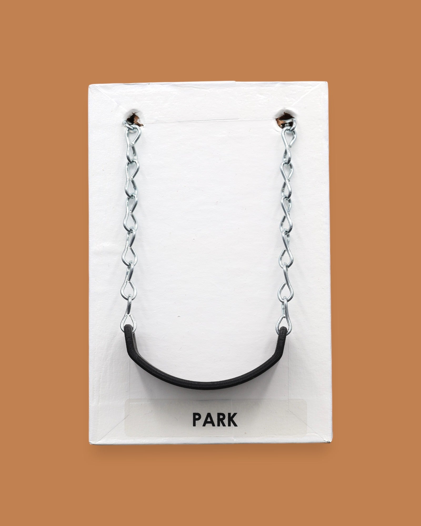 The Park Swing symbol with a small life-like miniature swing embedded in the center. Labeled "Park" in black font on white backing at the bottom of the symbol. The background of the symbol is white. 