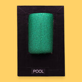 The Pool high contrast tactile symbol with a lime green pool noodle embedded vertically. Labeled "Pool" in white font on clear backing. The background of the symbol is black.  