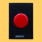 The Speech high contrast symbol with a red switch cap embedded in the center. Labeled "Speech" in white font at the bottom of symbol on clear backing. The background of the symbol is black. 