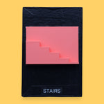 The Stairs symbol has a side profile of 3D printed stairs in bright coral orange PLA 3D printer filament. Labeled "Stairs" with black font on white backing at the bottom of symbol. The background of the symbol is white. 