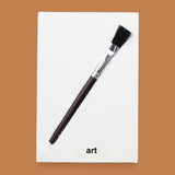 The Art symbol is crafted with a durable plastic paintbrush, the paintbrush handle color may vary. The paintbrush is embedded diagonally. Labeled "Art" in black font at the bottom of symbol on white backing. For Art symbol the backing is white with a varied high contrast colored paintbrush. 