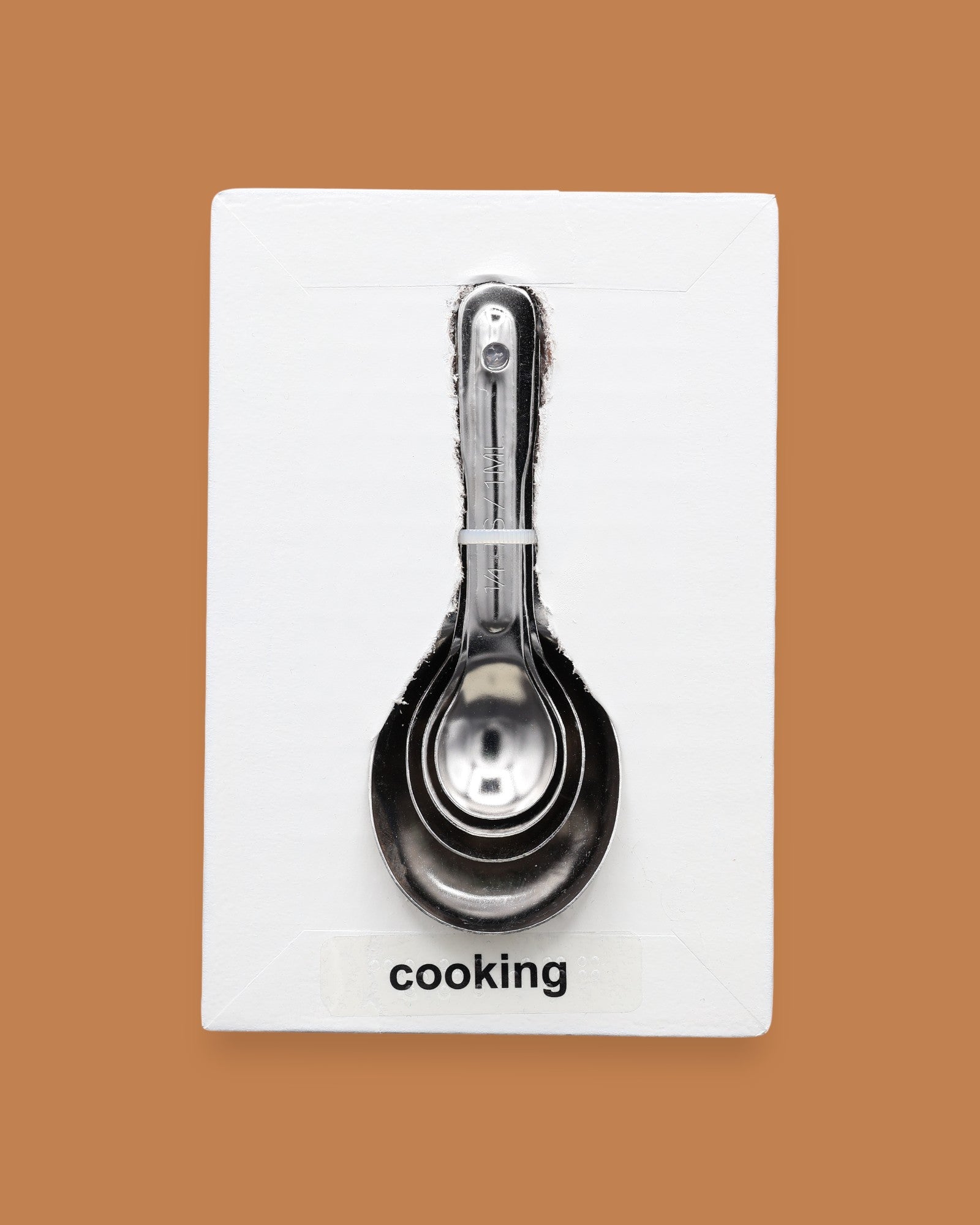 The Cookie symbol with a faux two tone brown chocolate chip cookie embedded in the center. Labeled "Cookie" in black font at the bottom of symbol on white backing.