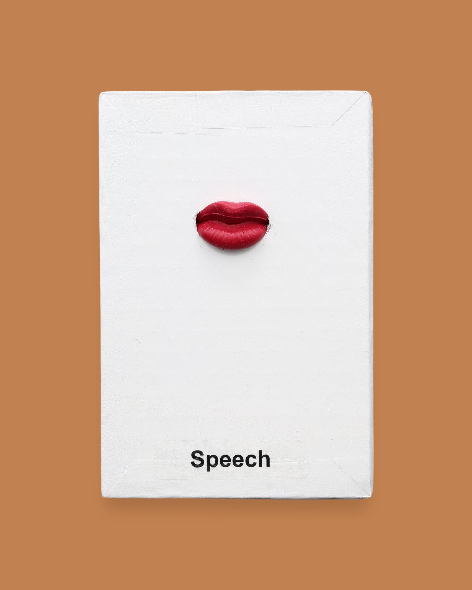 The Speech symbol with a medium red lip shape pencil top eraser embedded in the center. Labeled "Speech" in black font at the bottom of symbol on white backing. The background of the symbol is white.
