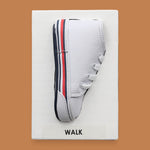 The Walk symbol features a toddler size sneaker embedded in the center. Labeled "Walk" in black font on black backing. The background of the symbol is black. 