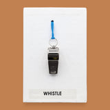 The Whistle symbol embedded with a sliver metal whistle attached with a blue cord embedded in the center of the card vertically. Labeled "Whistle" in black font on white backing at the bottom of the symbol. The background of the symbol is white. 