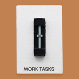 The Work Tasks symbol with an embedded bolt and nut assembly mounted on a black base vertically in the center. Labeled "Work Tasks" in black font on white backing at the bottom of the symbol. The background of the symbol is white. 